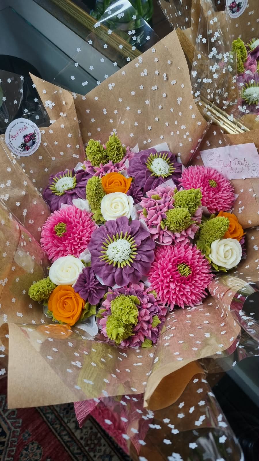 Cupcake bouquet with purple zinnias, pink chrysanthemums and orange roses