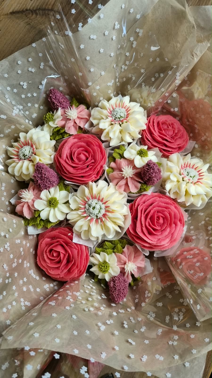Coral and cream floral cupcake bouquet wrapped in paper